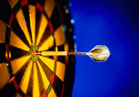 dart hitting a bullseye on the dart board