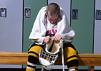 young hockey player in the locker room getting ready for the game
