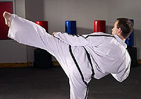 martial arts student practicing his kicking technique