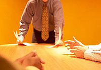 people in a meeting symbolizing communication and cooperation withing the Sudbury communities