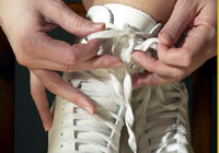 a figure skater lacing up her skates