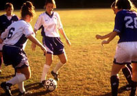 female soccer players making an attempt to take the ball