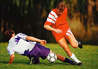 a soccer player trying to stop his opponent