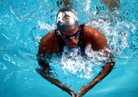 swimmer performing the breast stoke during a swim meet