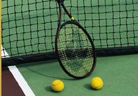 tennis racket and tennis balls on the court, resting against the net