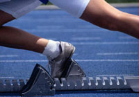 synchronized swimmer performing a routine in the pool - toes are pointed out of the water